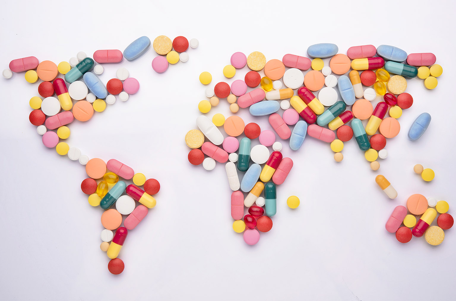 Stock photo of pills aligned to resemble world map.