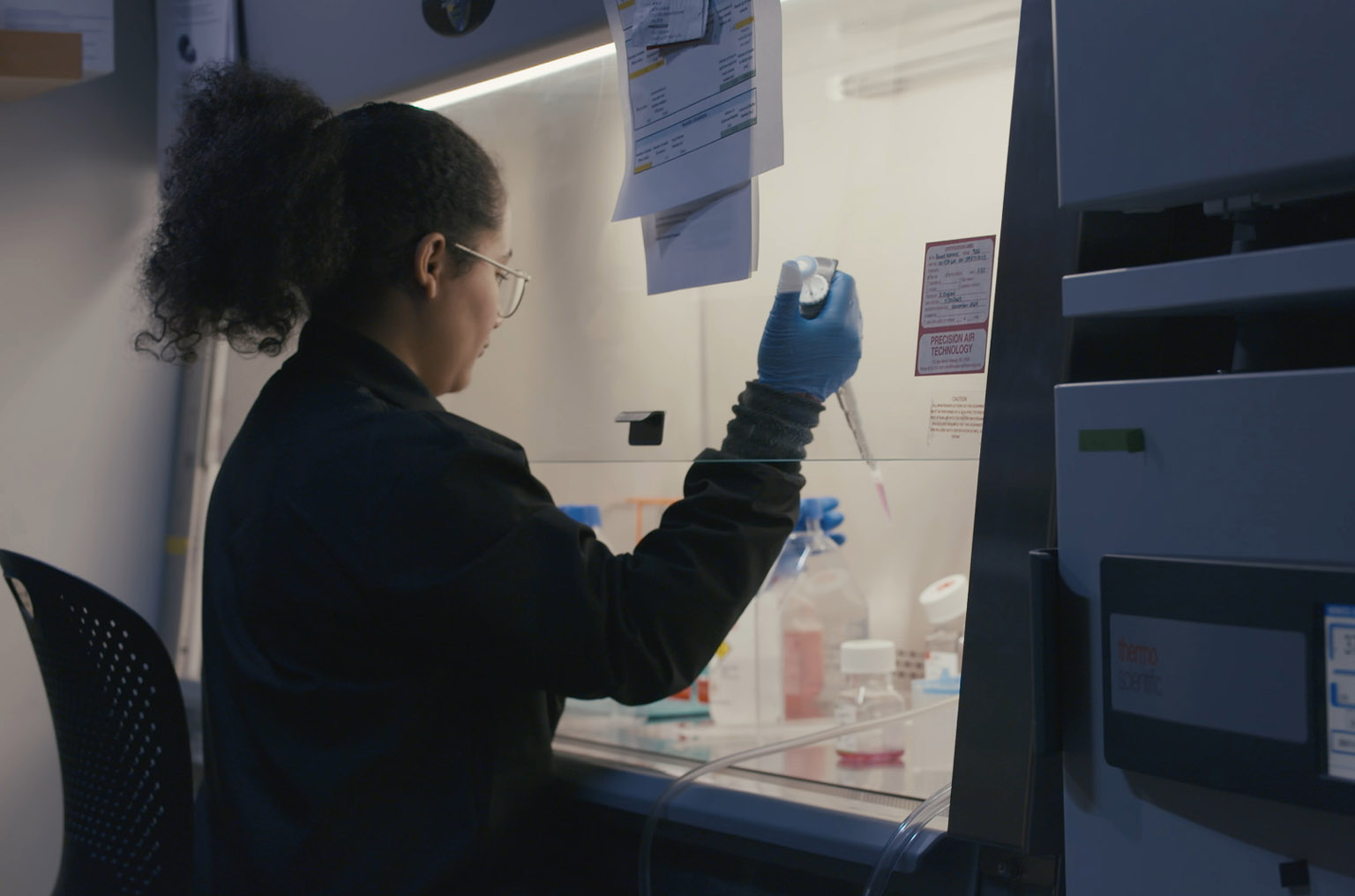 Female lab worker with a pipette