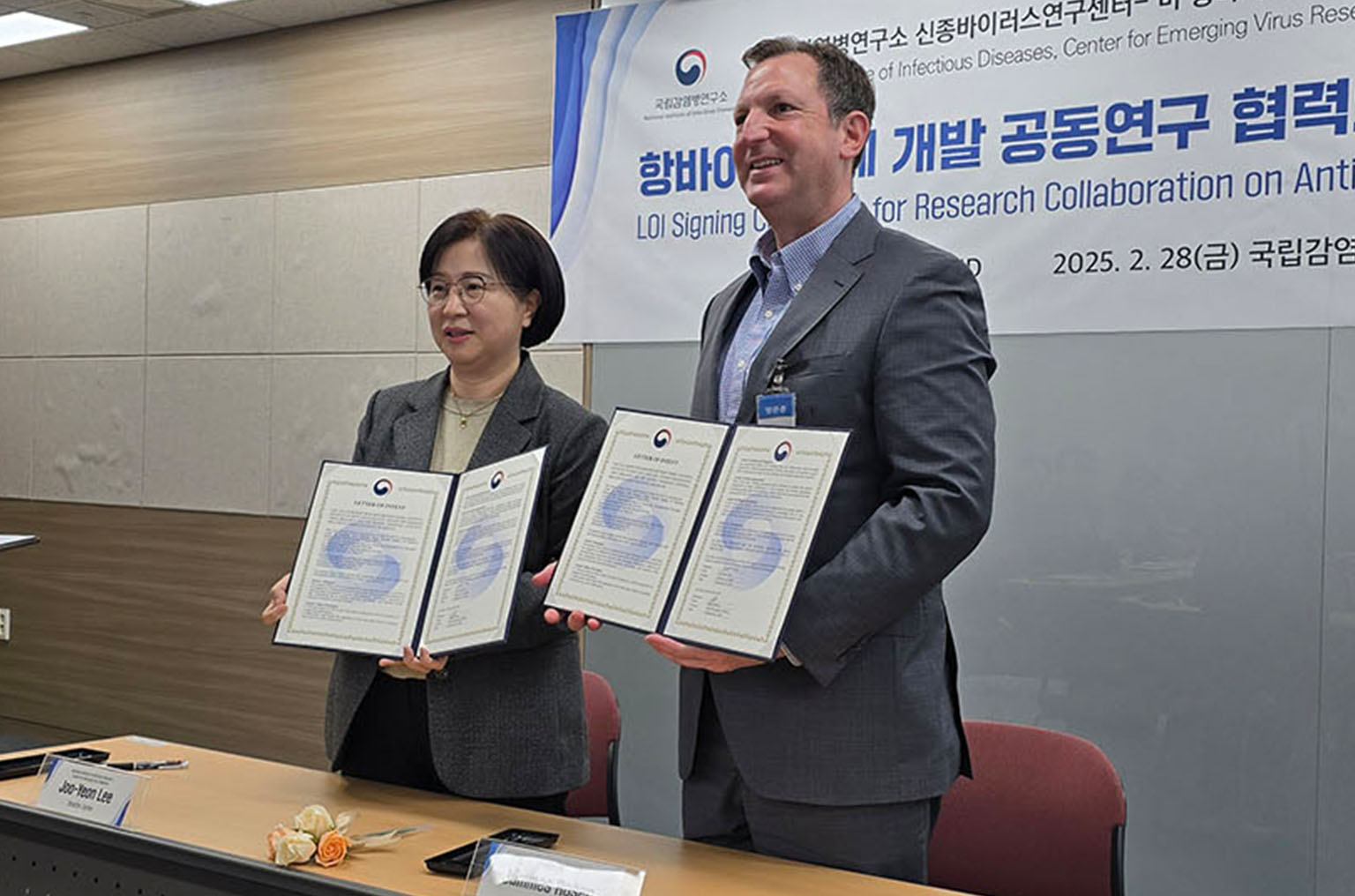 man and woman holding signed documents